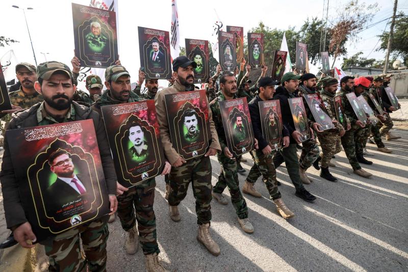 Haşdi Şabi Güçleri üyeleri, Bağdat'ta düzenlenen cenaze töreninde ABD hava saldırılarında öldürülenlerin fotoğraflarını taşıyor, 4 Şubat / Fotoğraf: AFP